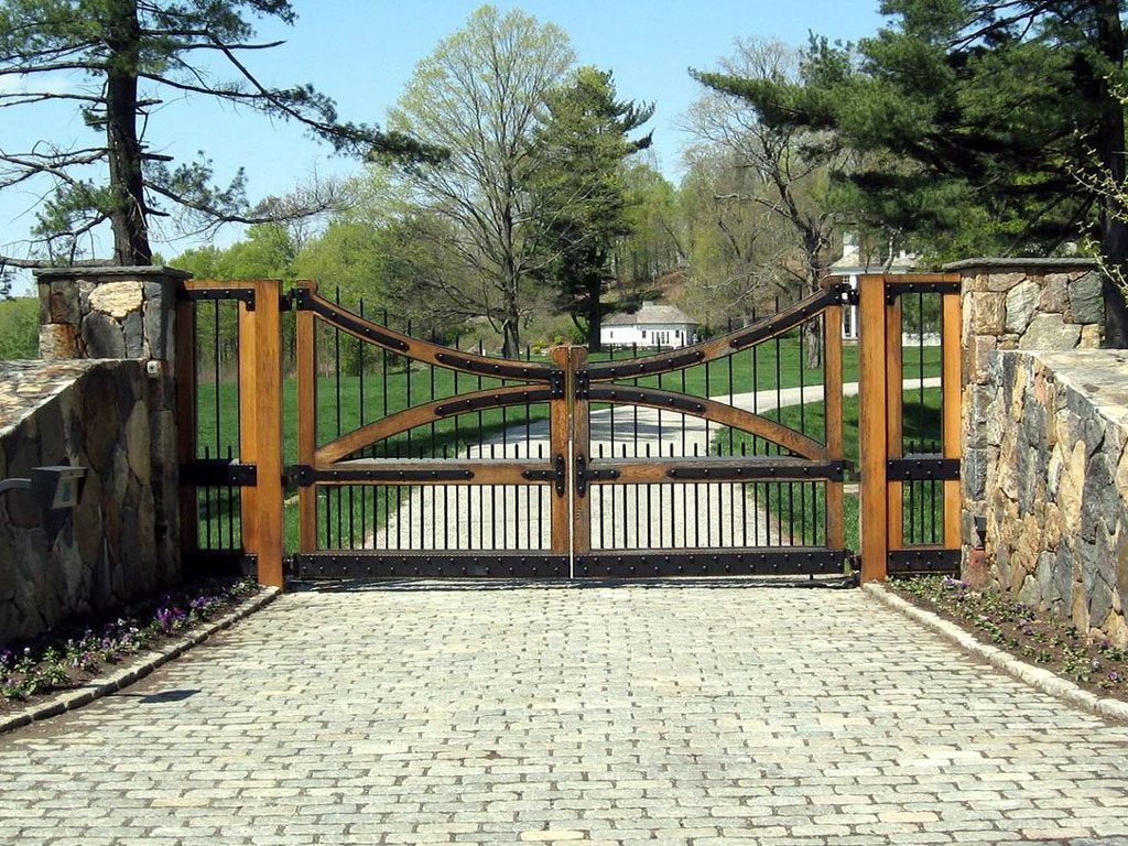 Spanish style wooden driveway gate with swinging gates