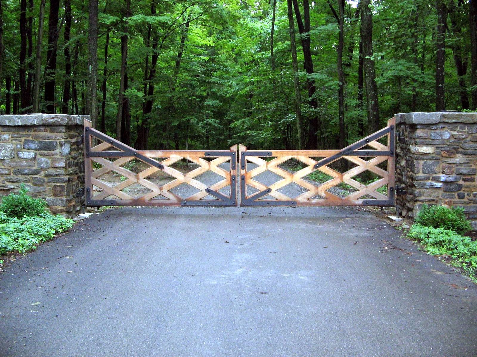 Low profile weathered wood gate with stone pillars