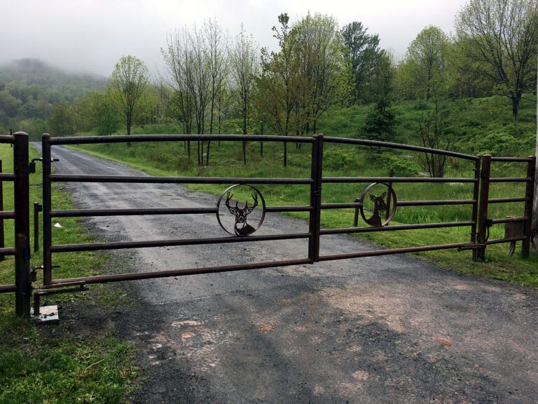 Custom driveway gate decorated with fabricated deer heads