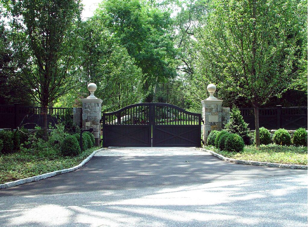Black Ranch Style Driveway Gate with Stone Pillars