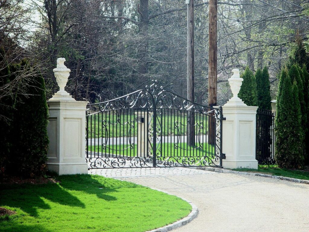 Metal Driveway Gate with Stone Pillars