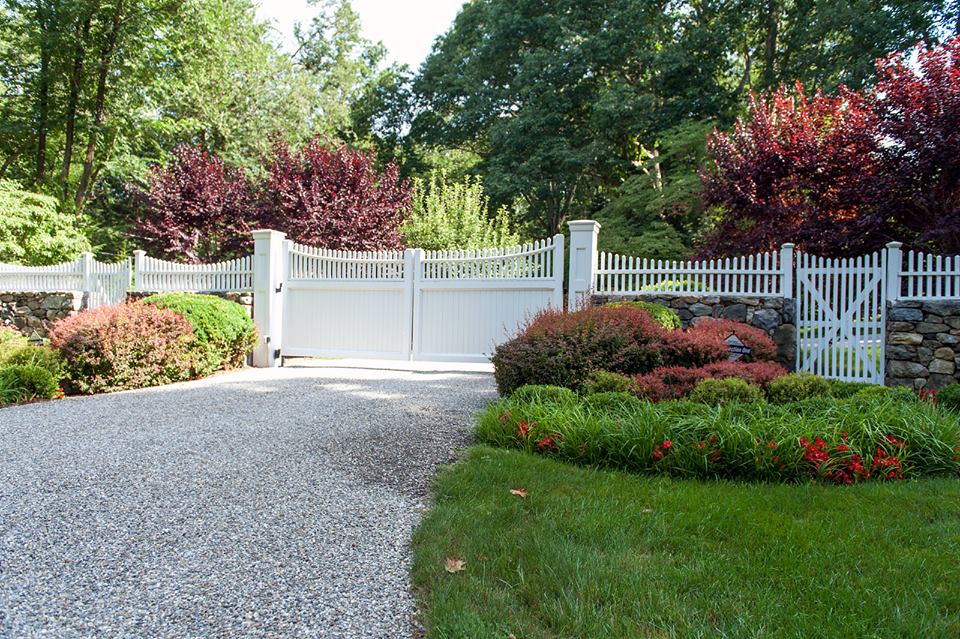 White wooden driveway gate with pickets