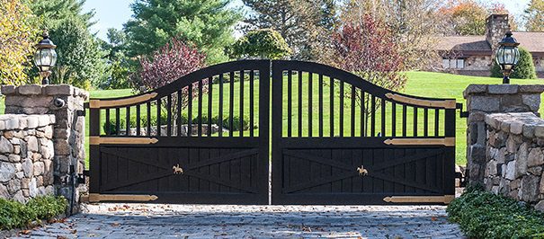 Scalloped wooden driveway gates with metal overlay