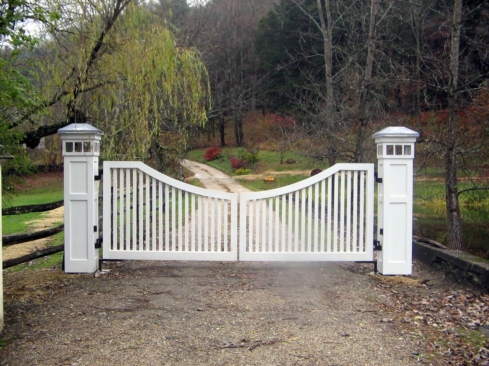 Wooden driveway gate with lighting on posts