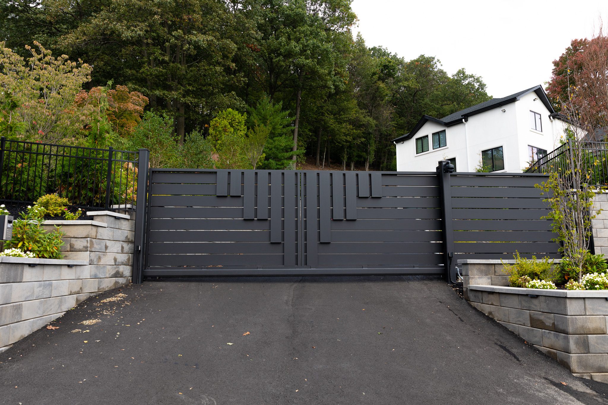 A black panel composite sliding driveway gate