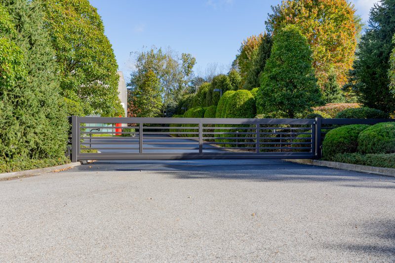 A Modern Gray Gate Has Fencing That Matches.
