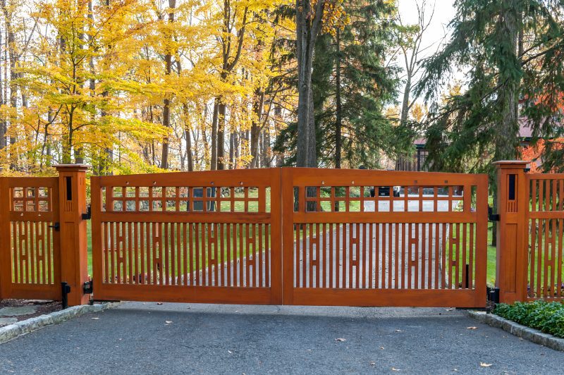An Ornate Wood Fence and Matching Gate.