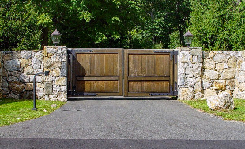 Rustic Wood Gate with Modern Stonework Columns.
