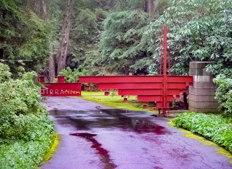 An Ultra Modern Red Gate with Gray Stone Columns.
