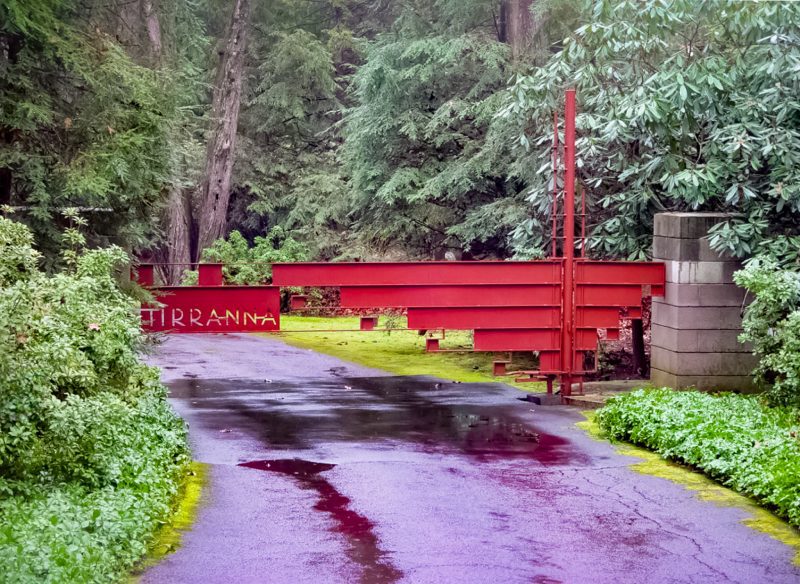 An Ultra Modern Red Gate with Gray Stone Columns.