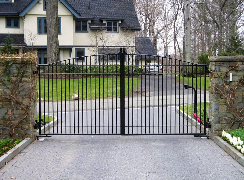 A Tall Wrought Iron Driveway Gate with Callbox.