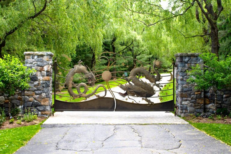 unique dragon decoration on metal gate with natural stone pillars