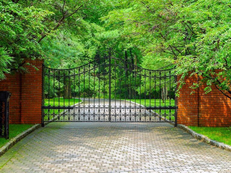 metal driveway gate with brick columns