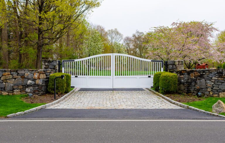 traditional white swing composite driveway gate with black hardware