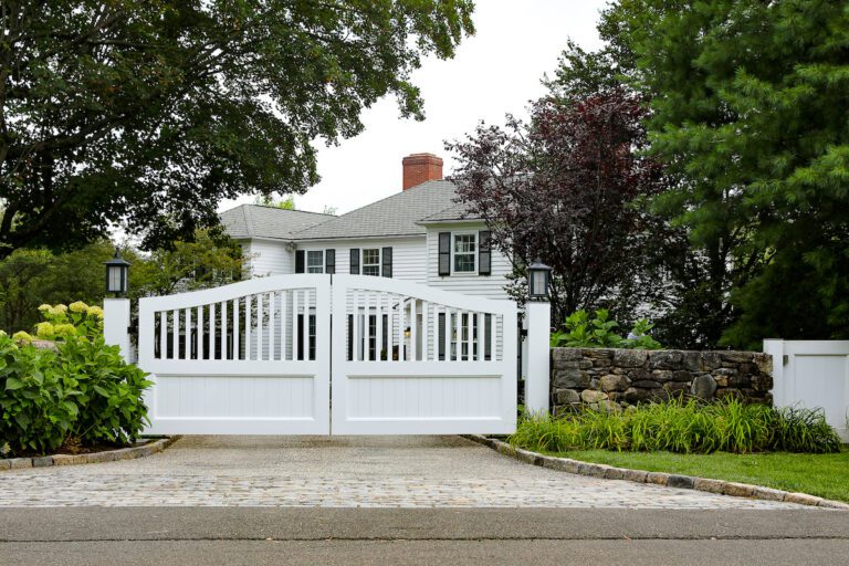 simple white composite driveway gate with lanterns