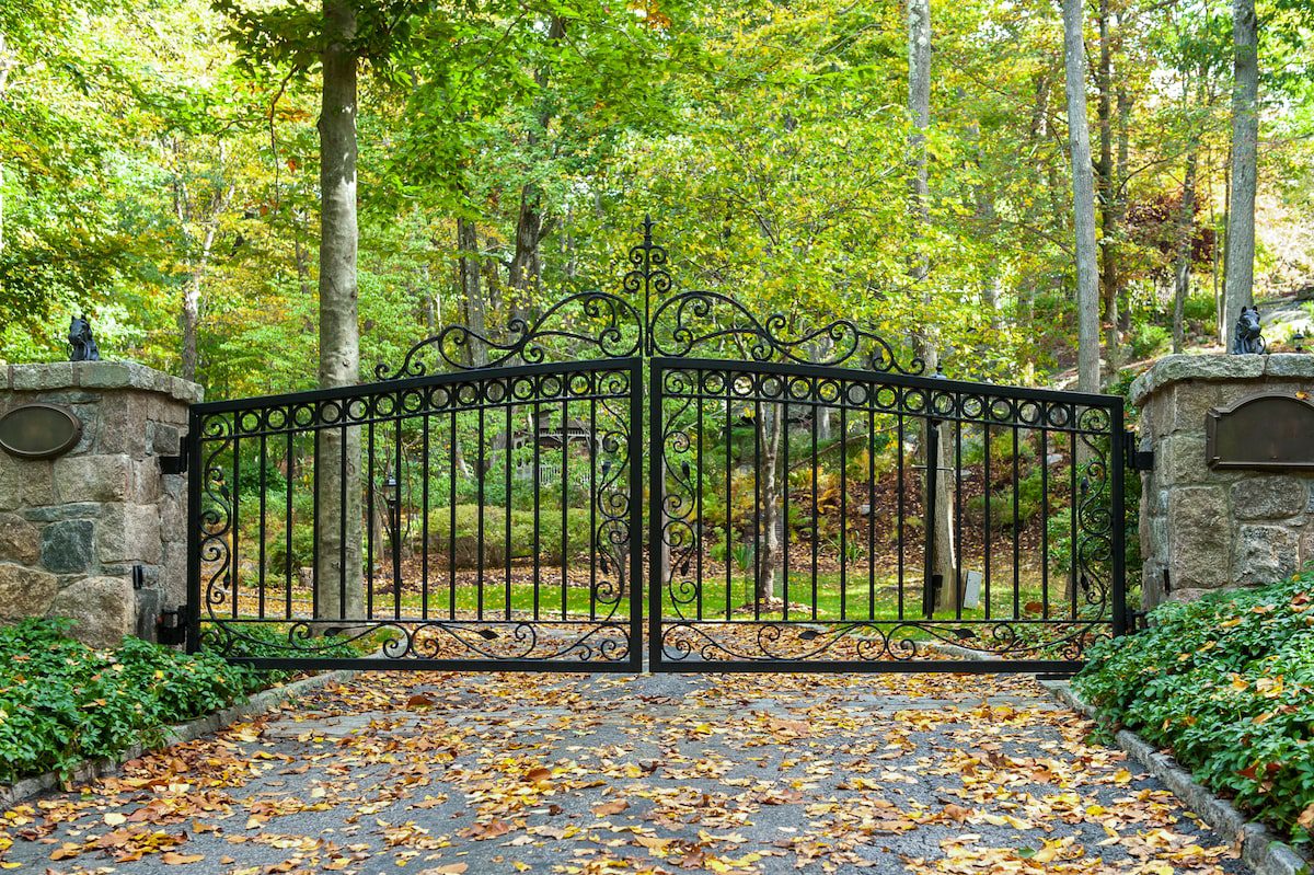 simple black metal driveway gate with subtle decoration at the top