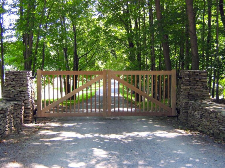 cedar farmhouse gate with lots of visibility and natural fence from flat stone