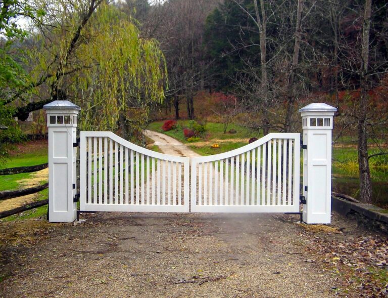 white scalloped farmhouse gate with columns and built in lighting