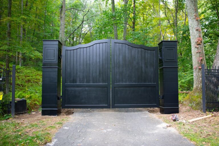 black wood driveway gate with matching pillars