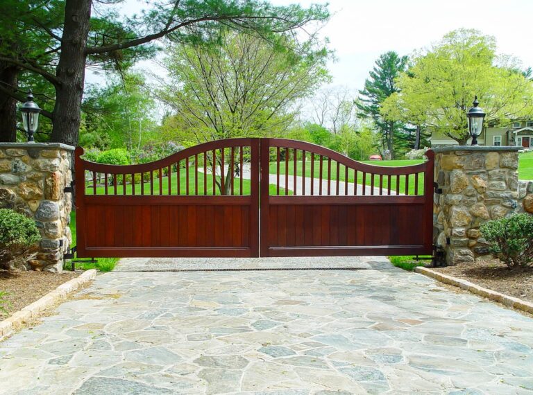 Traditional mahogany wood driveway gate with scallops and arch