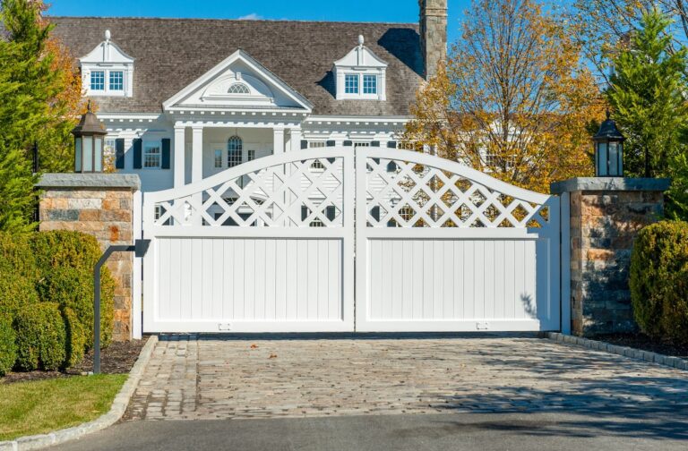 traditional white wood driveway gate with cross pattern