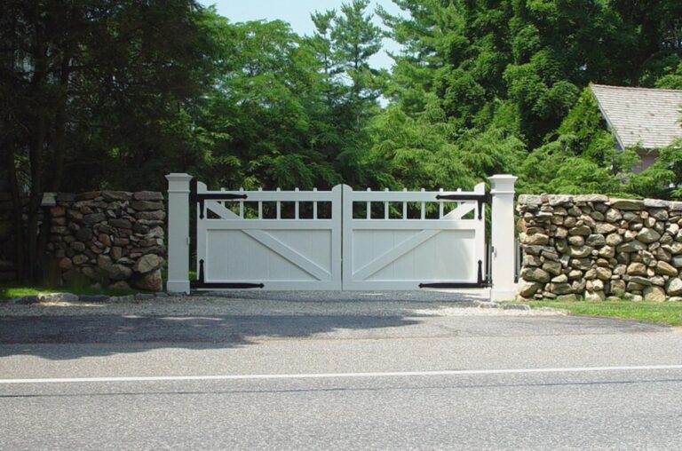 traditional white driveway gate with rectangular design and natural rounded stonework